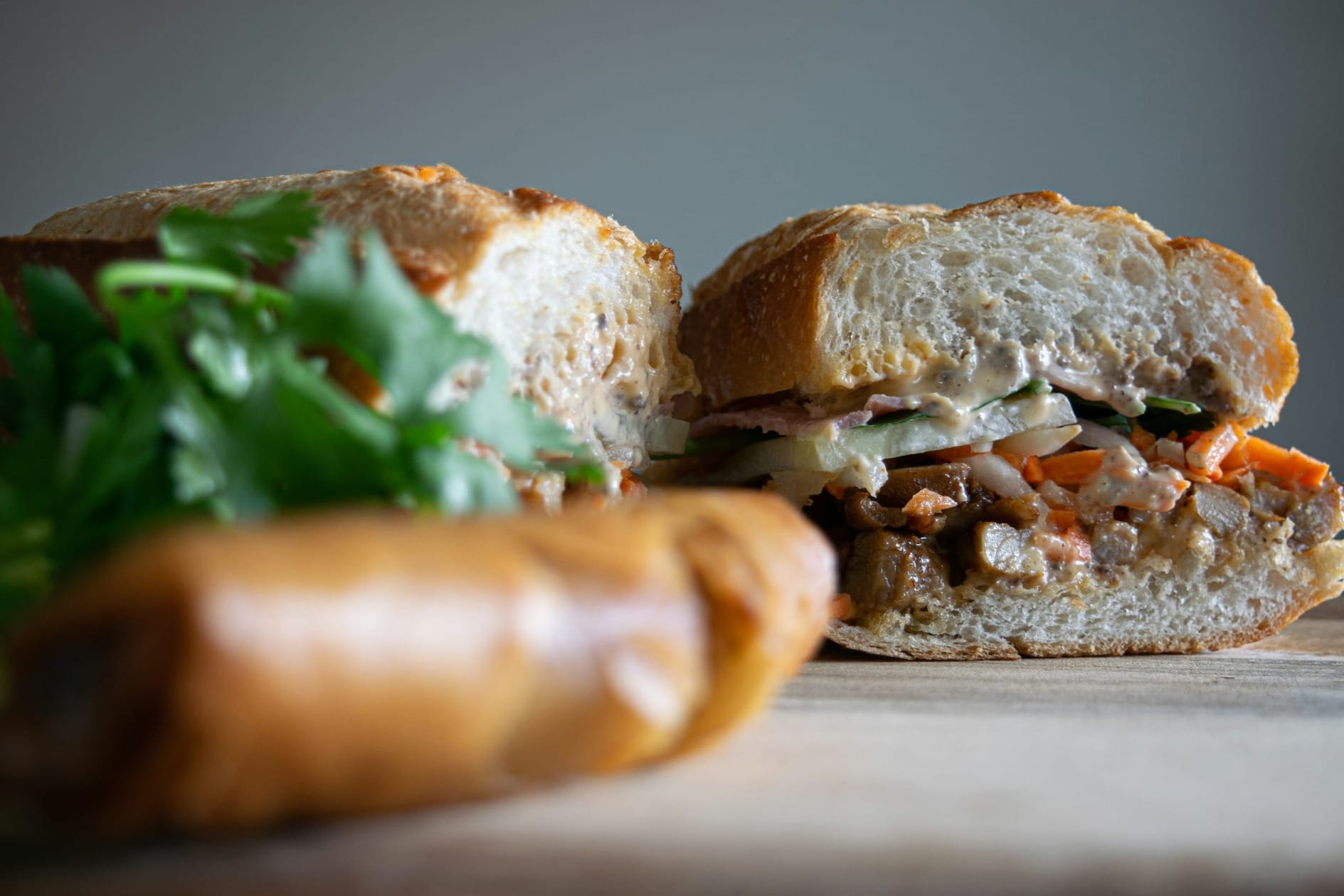 bread with green vegetable on brown wooden table