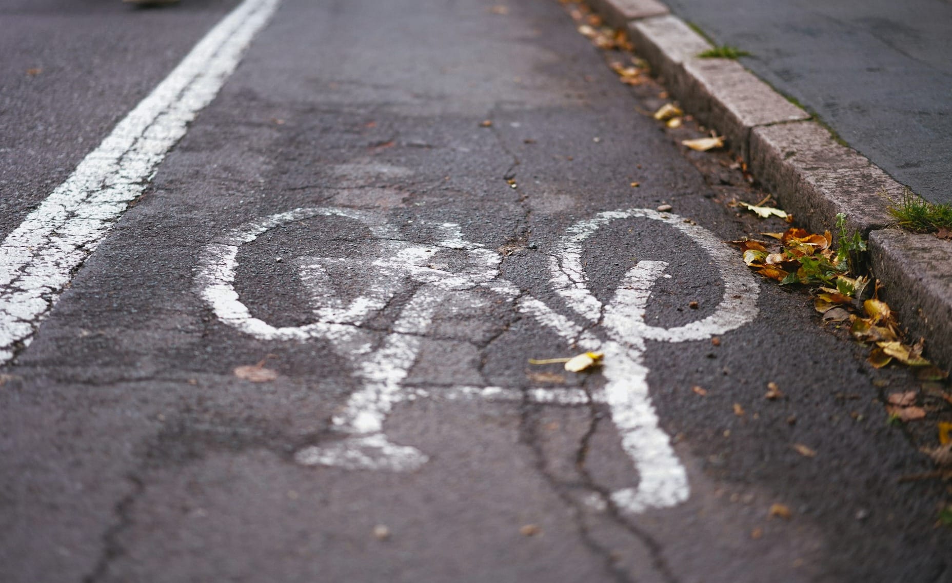 person in blue denim jeans walking on pedestrian lane during daytime